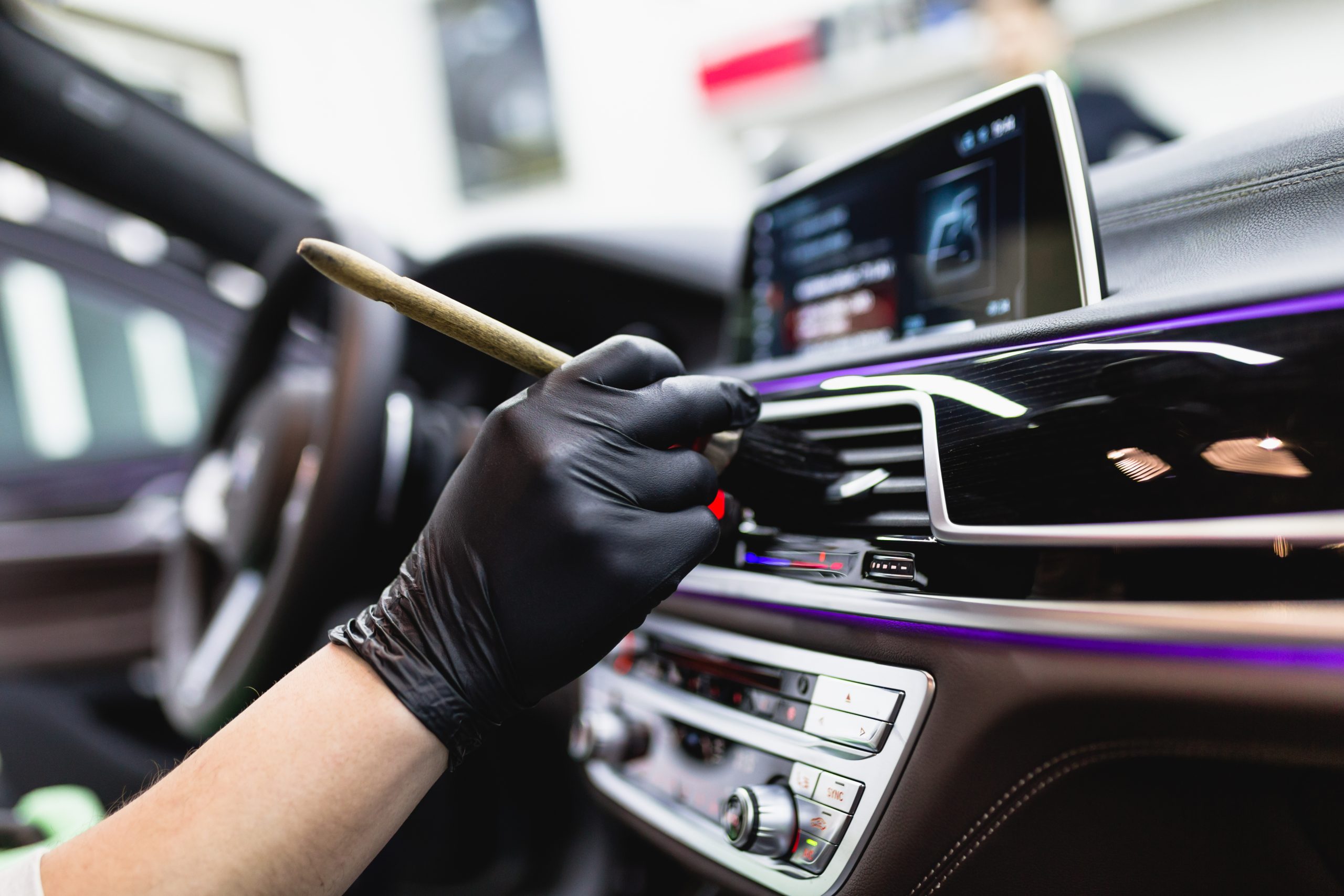 A man cleaning car interior, car detailing (or valeting) concept